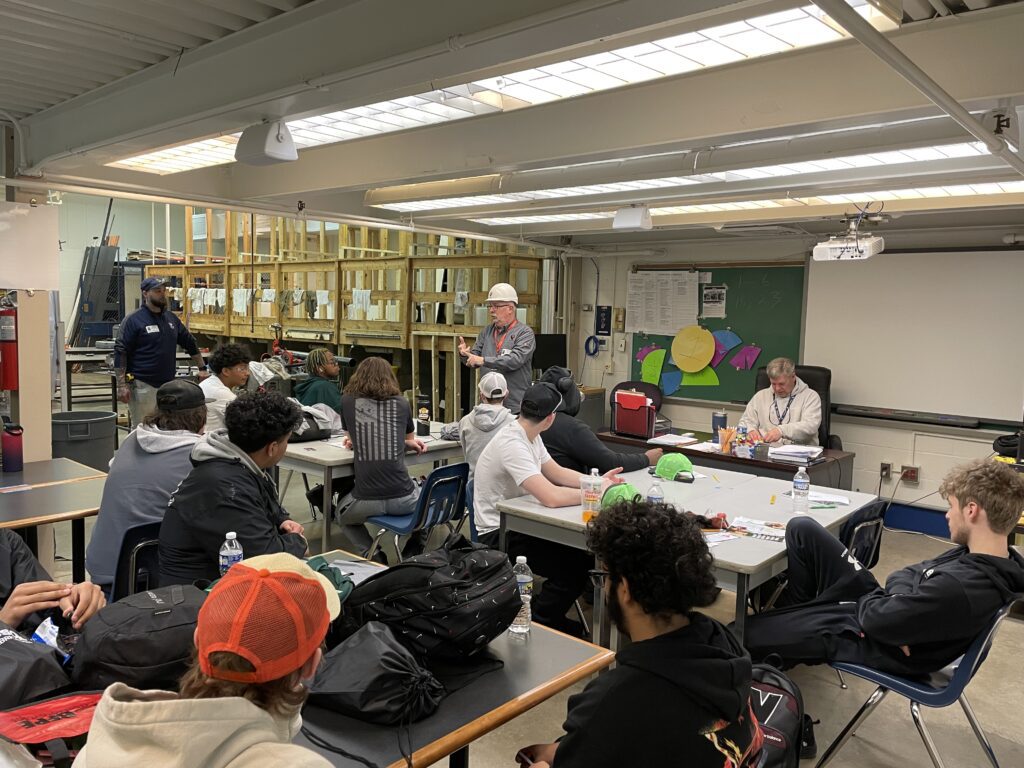 Dave Victor talking to a group of students in a classroom.